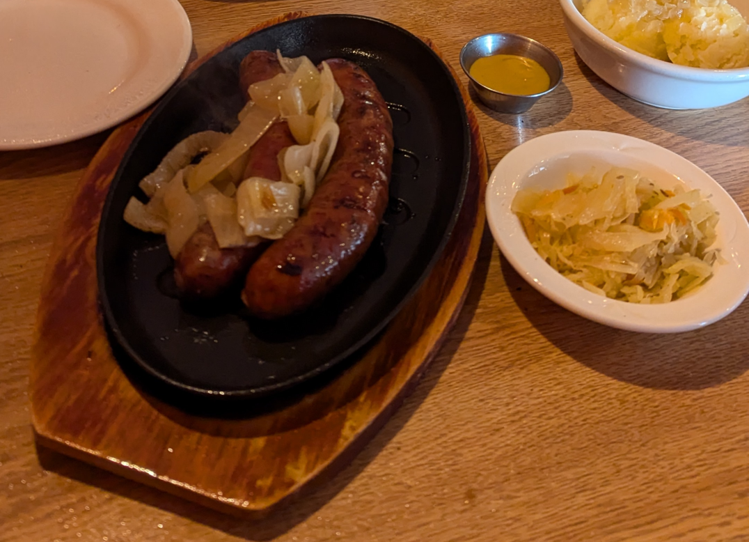 sizzling platter with onions and kielbasa, side of sauerkraut